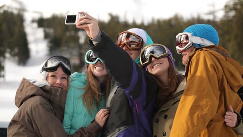 Group of snowboarders take self portrait together