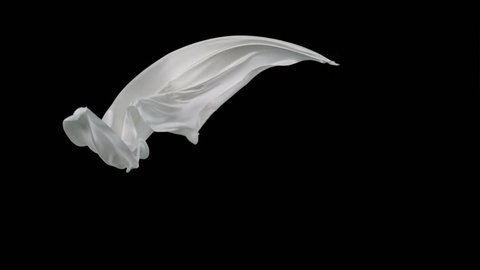 White fabric flowing in the air on black background shooting with high speed camera, phantom flex.