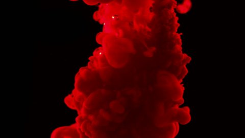 Red ink dropped in water on black background shooting with high speed camera, phantom flex.