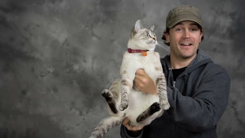 Man and woman couple pose for photo shoot with their two cats. Stock Video