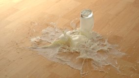 Dropping glass of milk and breaking on wooden floor shooting with high speed camera, phantom flex. - Powered by Shutterstock - Get 15% off with code: PIKWIZARD15