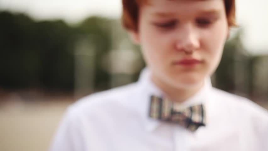 Street Fashion. Cute red-haired boy with butterfly tie
