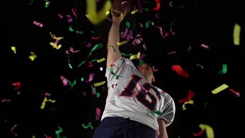 American football player celebrating his winning with confetti shooting with high speed camera, phantom flex. isolated. 
