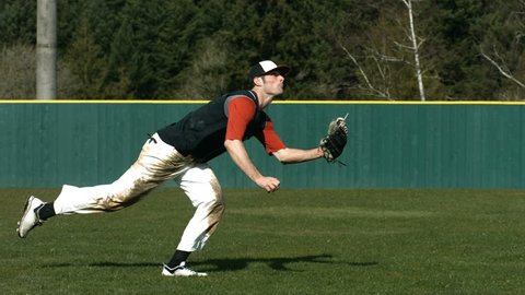 Baseball player catching ball, slow motion