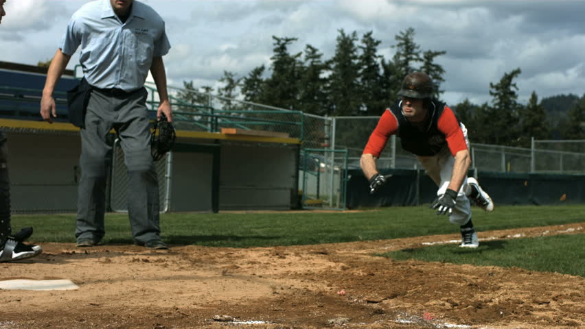 Baseball player slides into home plate, slow motion Royalty-Free Stock Footage #4630016