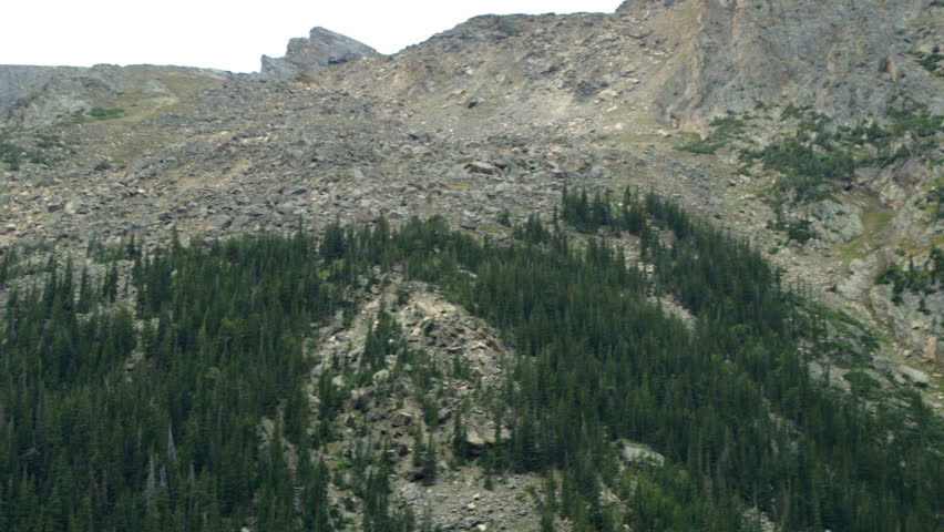 Scars of a past rock slide on the side of a mountain in Rocky Mountain National Park. Handheld, organic feel, natural lighting