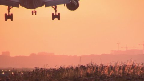 Huge Airplane landing at sunrise