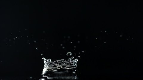 Water drop making splash on black background shooting with high speed camera, phantom flex.