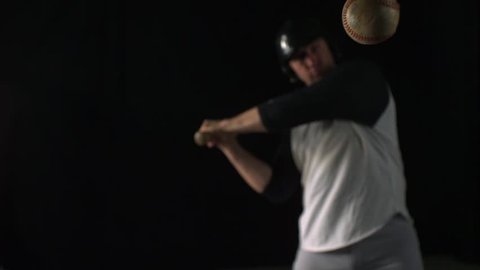 Baseball player hitting ball with bat shooting with high speed camera, phantom flex.