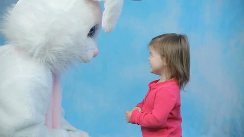 Easter bunny gives egg to child