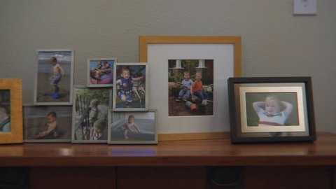 Framed family photos on a fireplace