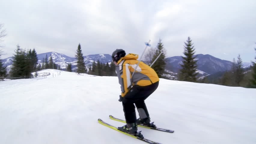 Motion camera view of skier is riding in the mountains