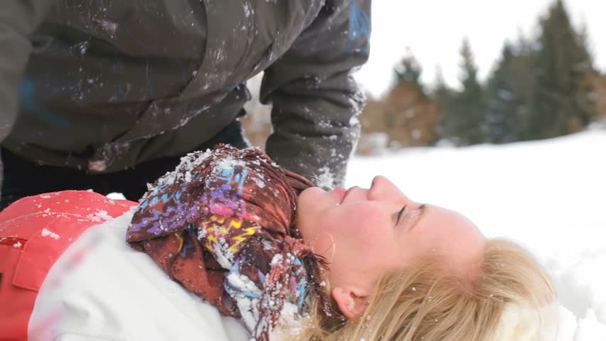 Cute couple kiss on in snow