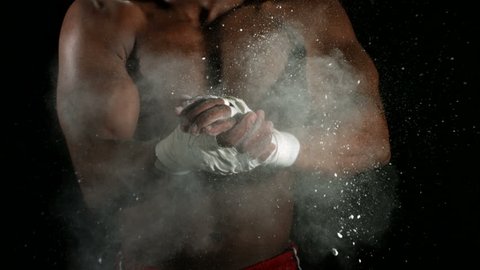 Boxer claps together hands with talcum powder