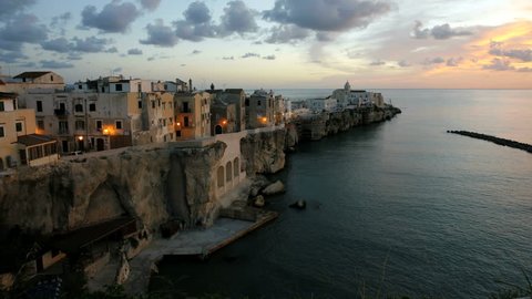 Time lapse at sunrise of Vieste town built a rocky promontory into the Adriatic Sea in Italy