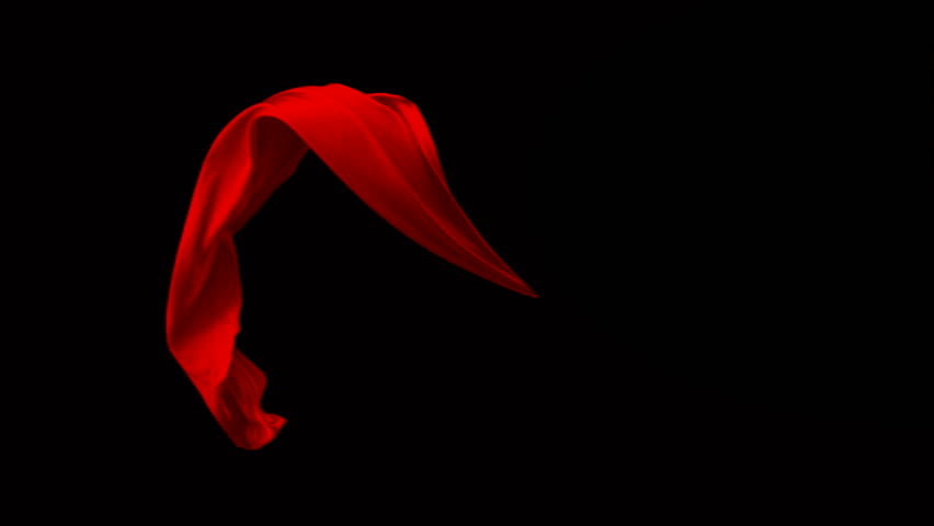 Red fabric flowing in the air on black background shooting with high speed camera, phantom flex.