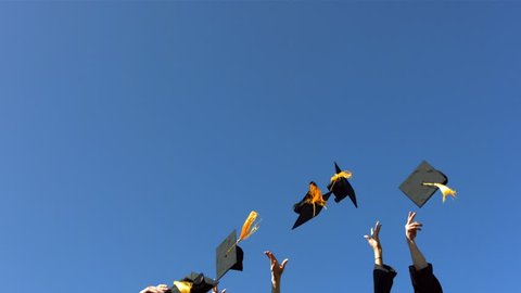 Throwing graduation caps, slow motion