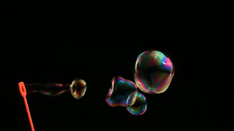Colorful bubbles over black background 库存视频