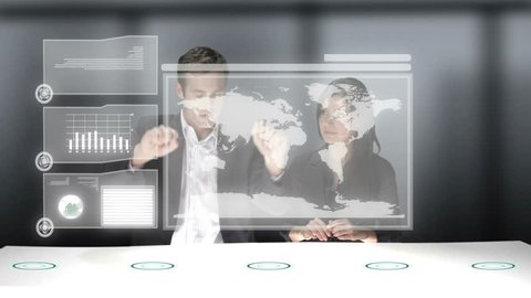 Two business professionals use a computer generated video wall to look over the stats of their company. Medium CG shot.