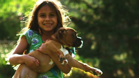 A little girl runs and plays with a little dog. Medium shot.