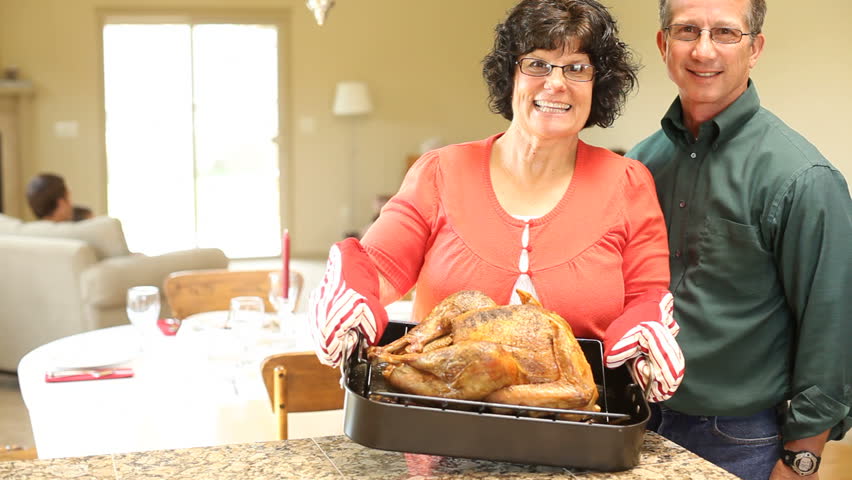 Couple holds turkey on Thanksgiving