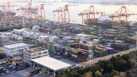 Japan - March 2011: Time lapse view of activity at a busy Japanese Cargo Container Port with the arrival of a commercial cargo ship in, Odaiba, Tokyo, Japan in March, 2011