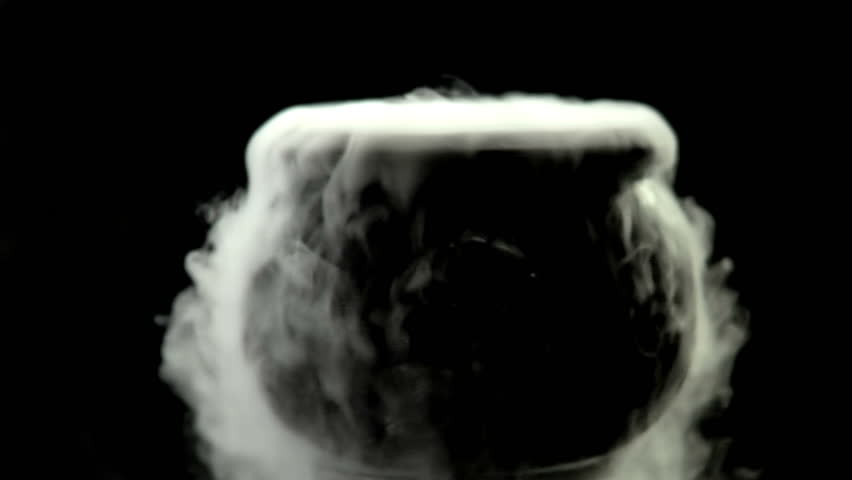 Steaming cauldron. Overflowing with steamy smoke on a black background. Royalty-Free Stock Footage #4645388