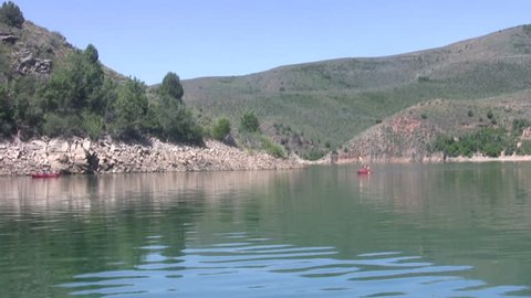 Video of high elevation mountain lake Utah Wasatch Mountains.  Lost Creek State Park.  Kayak paddling. From moving boat. Outside of Morgan and Ogden Utah, USA. Don Despain of Rekindle Photo