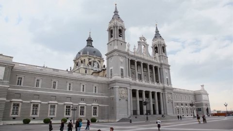 MADRID - MARCH 10: People walk near Cathedral of Nuestra Senora de la Almudena on 10 March 2012 in Madrid, Spain. In 2012 number of tourists in resorts of Spain increased 1.5 times compared to 2011.