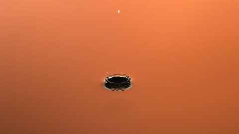 Slow motion water droplet, orange