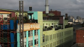 A time lapse of a crane and elevator working near a building in Brooklyn NY. Wide shot.
