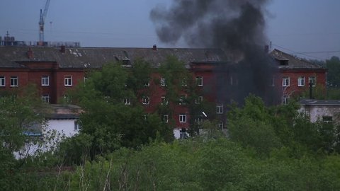 Black smoke in a residential area. Fire in Omsk. Russia.