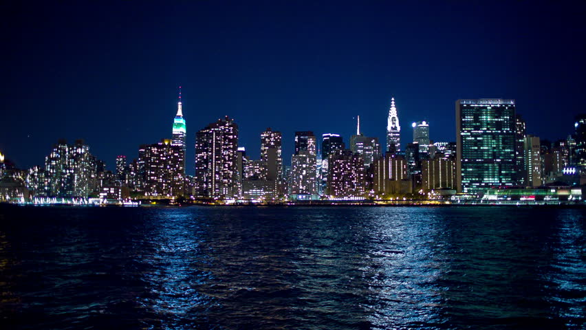 NEW YORK - SEPTEMBER 9, 2013: Manhattan Skyline on beautiful night with Empire State Building and East River in NYC, New York, USA. Manhattan is smallest New York City borough; most densely populated.