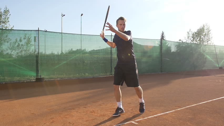 Slow Motion Shot Of A Professional Tennis Player Hitting The Ball With Tennis
