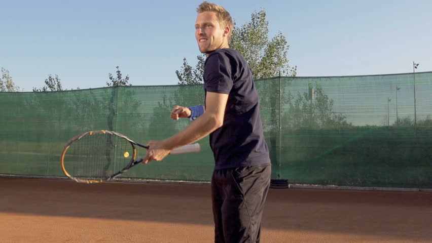 Slow Motion Shot Of Professional Tennis Player Hitting Backhand And Expressing