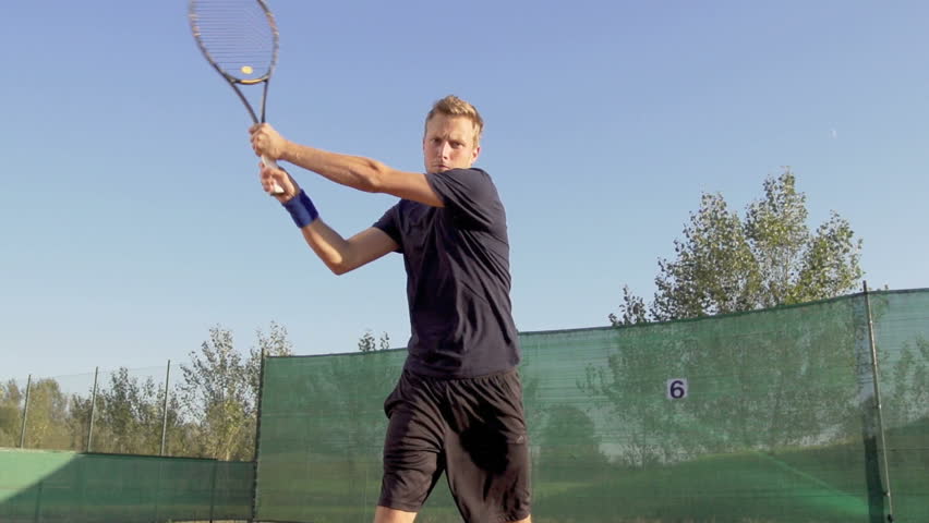 Slow Motion Shot Of A Professional Tennis Player Hitting Two Handed Backhand On
