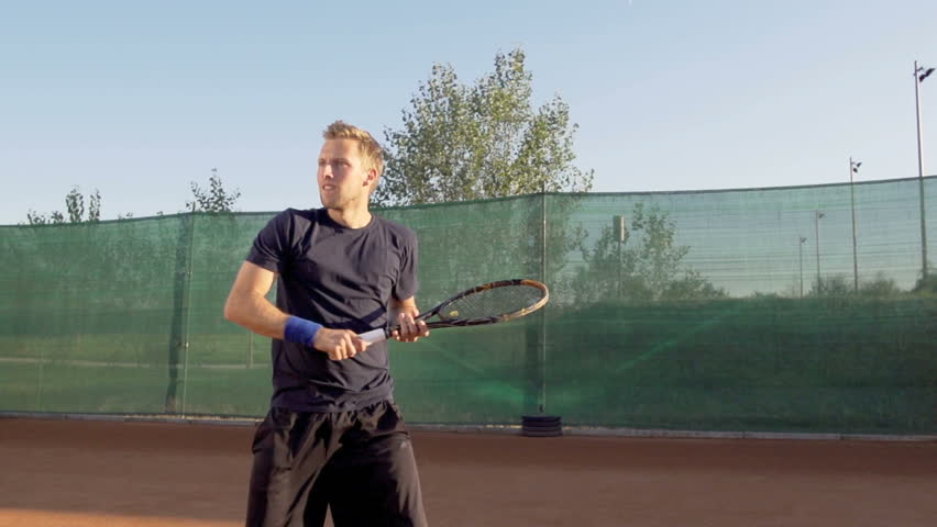 Slow Motion Shot Of Professional Tennis Player Hitting Forehand And Expressing
