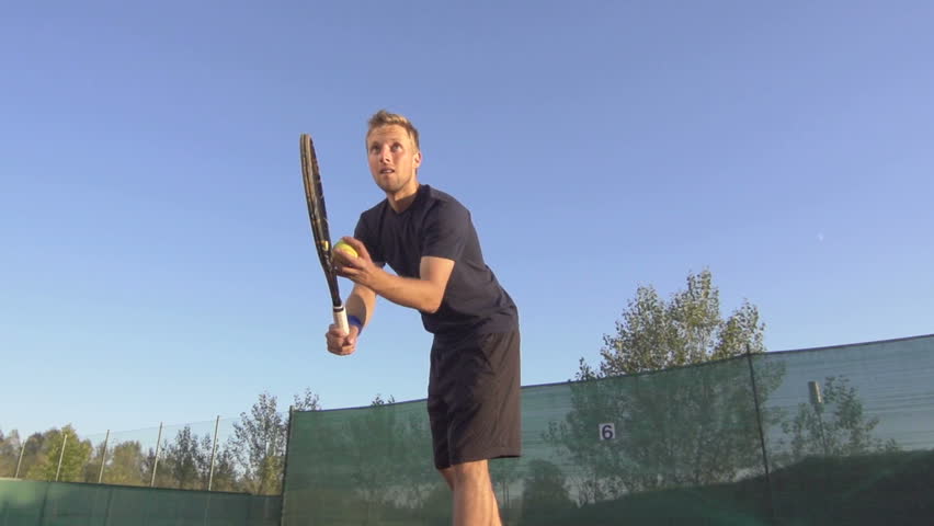 Slow Motion Shot Of A Professional Tennis Player Serving A Tennis Ball