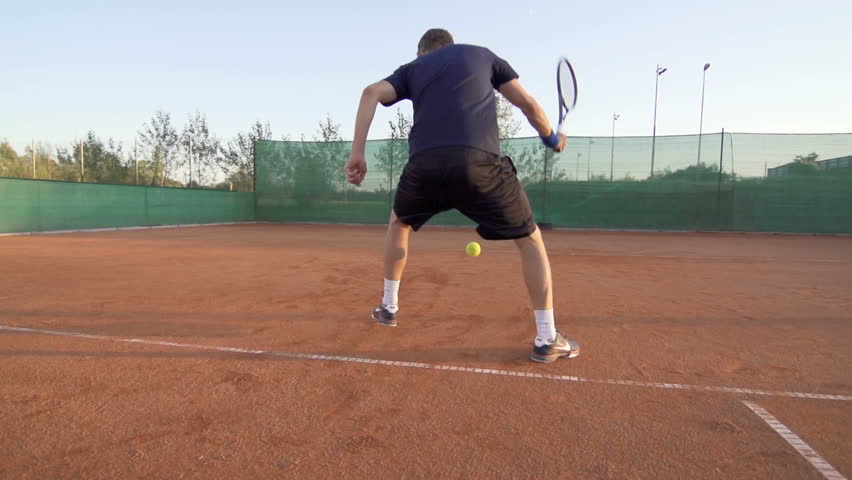 Slow Motion Shot Of A Professional Tennis Player Hitting The Ball From In