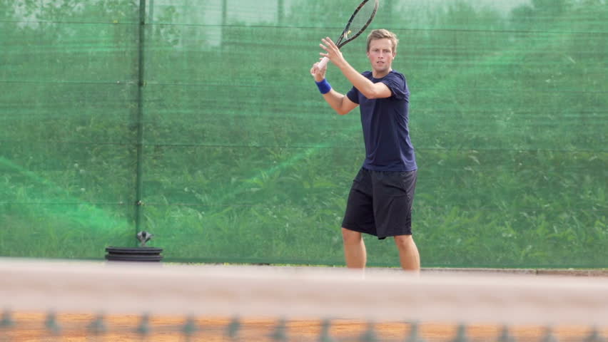 Slow Motion Shot Of A Professional Tennis Player Playing Tennis On Clay Court 