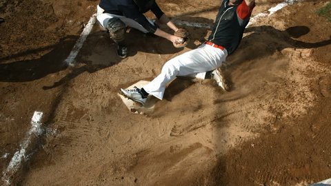 Overhead view of baseball player sliding into home plate