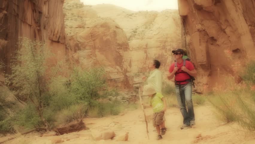 A family in a desert slot canyon in capitol reef national park