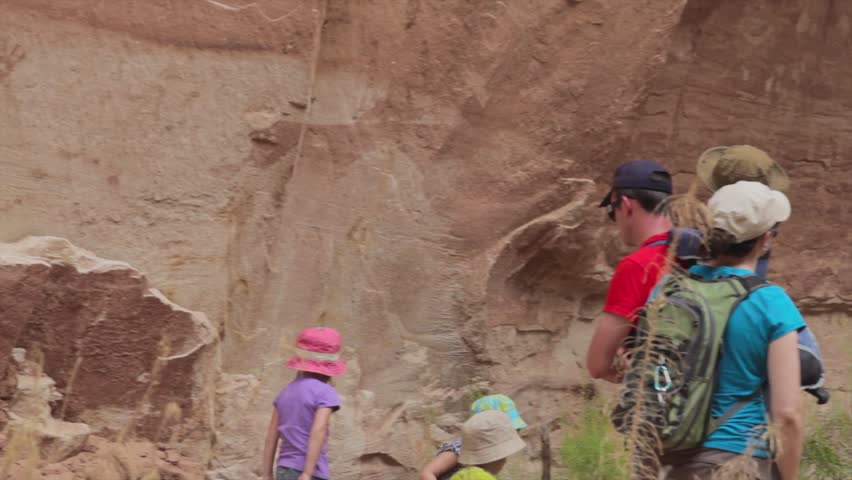 Family looking at petroglyph indian art