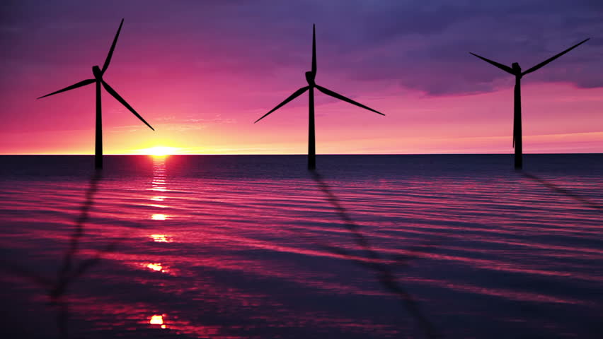 The calm sea. Sunset. Wind farm work