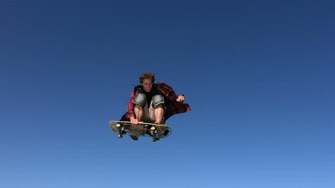 Skateboarder flying in air, slow motion