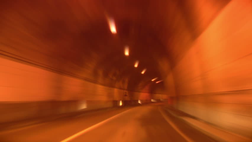 Driving through tunnel, abstract with motion blur and glow.