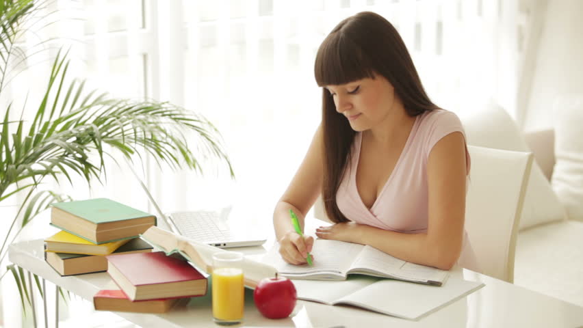 She sat at the table. Стартапер женщина взбалмышная. GIRLREADING at the Table. The girl is sitting at the Table and writing.