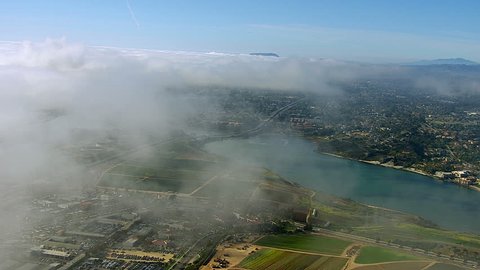 Flying through clouds over Carlsbad California Stock Video
