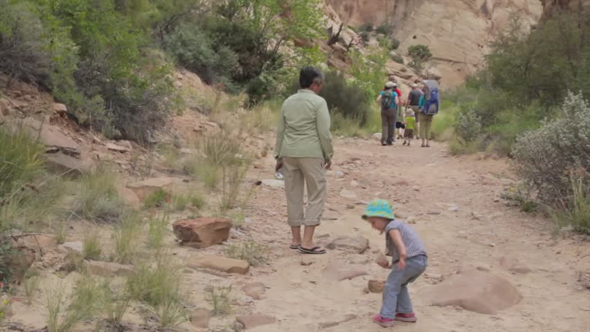 A family hiking in a cool desert slot canyon