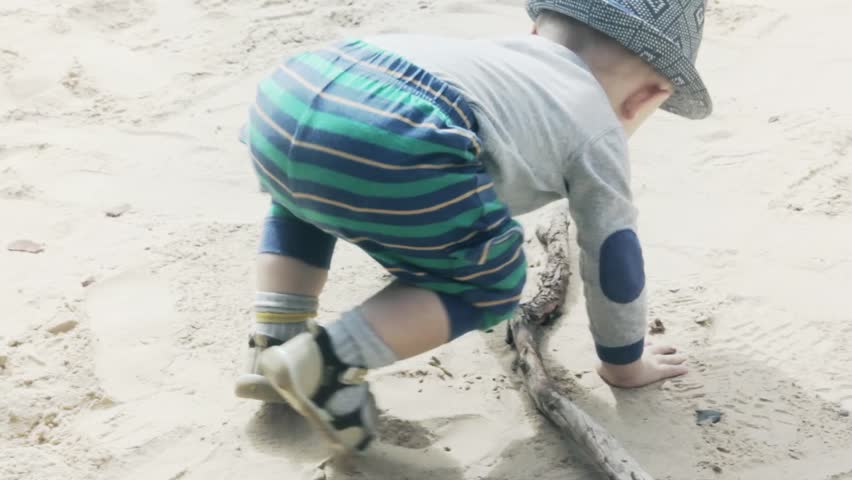 A toddler playing in the desert sand